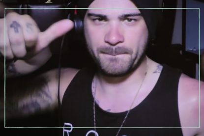 a photo of Hunter Moore now posing with his thumbs up in a black vest top