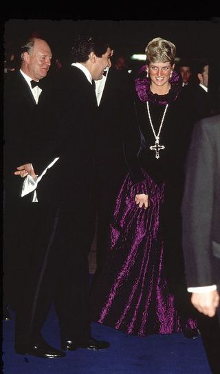 Diana, Princess Of Wales, Arriving At A Charity Gala Evening On Behalf Of Birthright At Garrard. The Princess Is Wearing A Purple Evening Dress With A Gold And Amethyst Crucifix Suspended On A Pearl Rope.