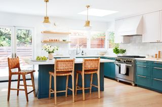 white kitchen with blue kitchen cabinets by Banner Day Interiors