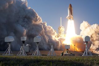 Cameras photograph space shuttle Discovery lifting off from NASA's Kennedy Space Center in Florida beginning its final flight, the STS-133 mission to the International Space Station, on Feb. 24, 2011.