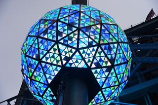 The Big Ball, illuminated in blue, goes through the Philips Ball Test at Times Square on December 30, 2015 in New York City