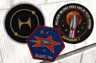 The mission patches for the three-way race to the Red Planet from the third season of "For All Mankind." Official mission patch replicas are now available from IconHeroes.com.