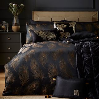 bedroom with black sateen fabric and gold embroidered with peacock feathers