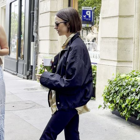 An image of Lily Collins wearing capri leggings and a white ballet flats. 