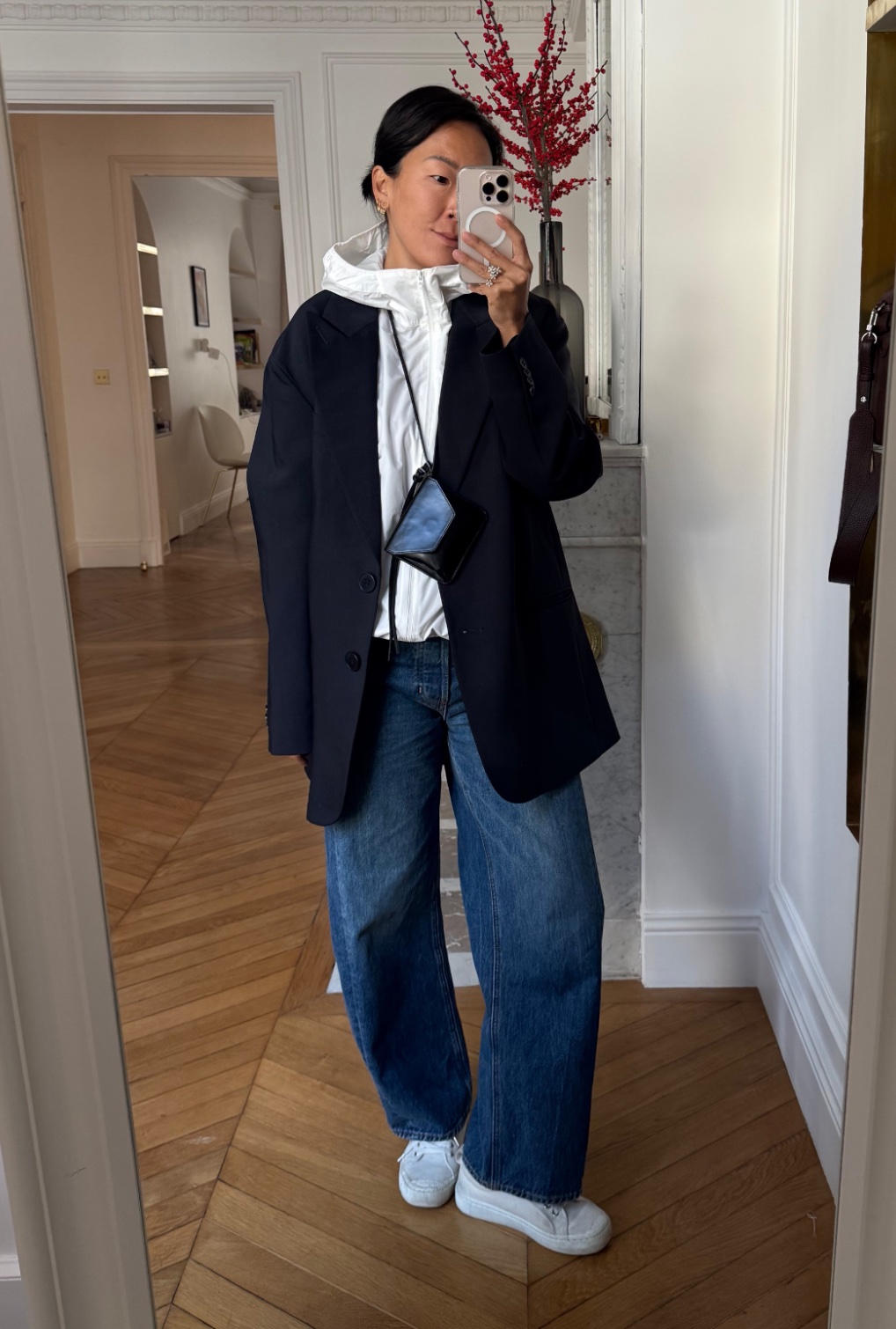 Irene Kim wearing blazer, windbreaker, jeans, and sneakers