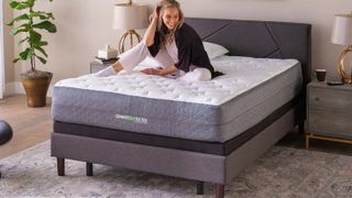 GhostBed Luxe mattress feature image has a woman sitting across the bed