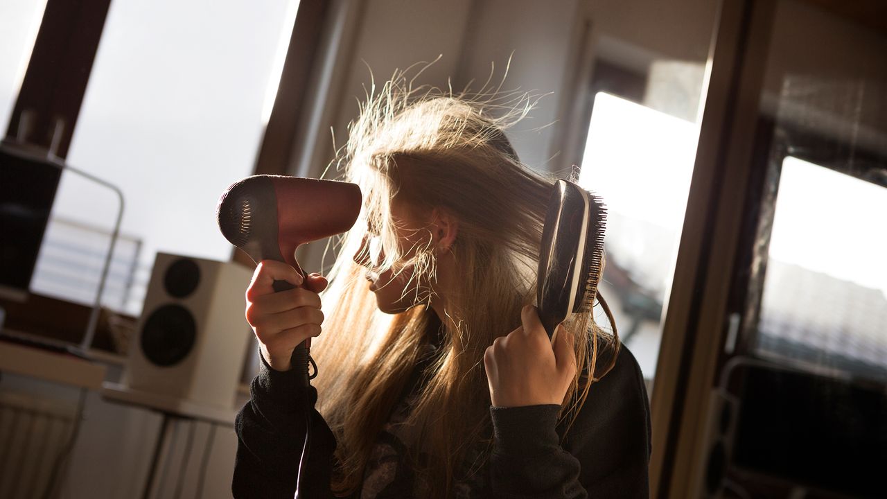 woman drying her hair