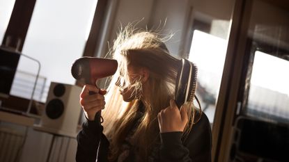 woman drying her hair