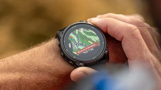 Garmin Enduro 3 watch on wrist of tattooed male