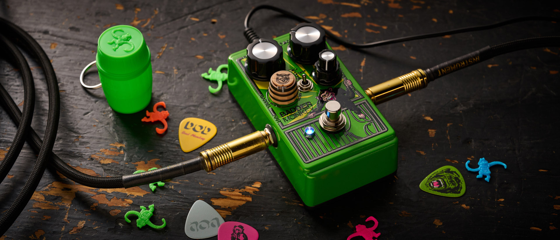 The DOD Badder Monkey is another little green overdrive pedal – but like no other. Pictured here against a distressed wooden floor, it has a wooden barrel control, and a primate illustration on the front.