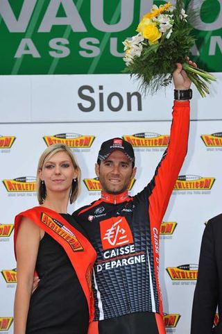 Alejandro Valverde salutes from the podium in a soggy Sion.