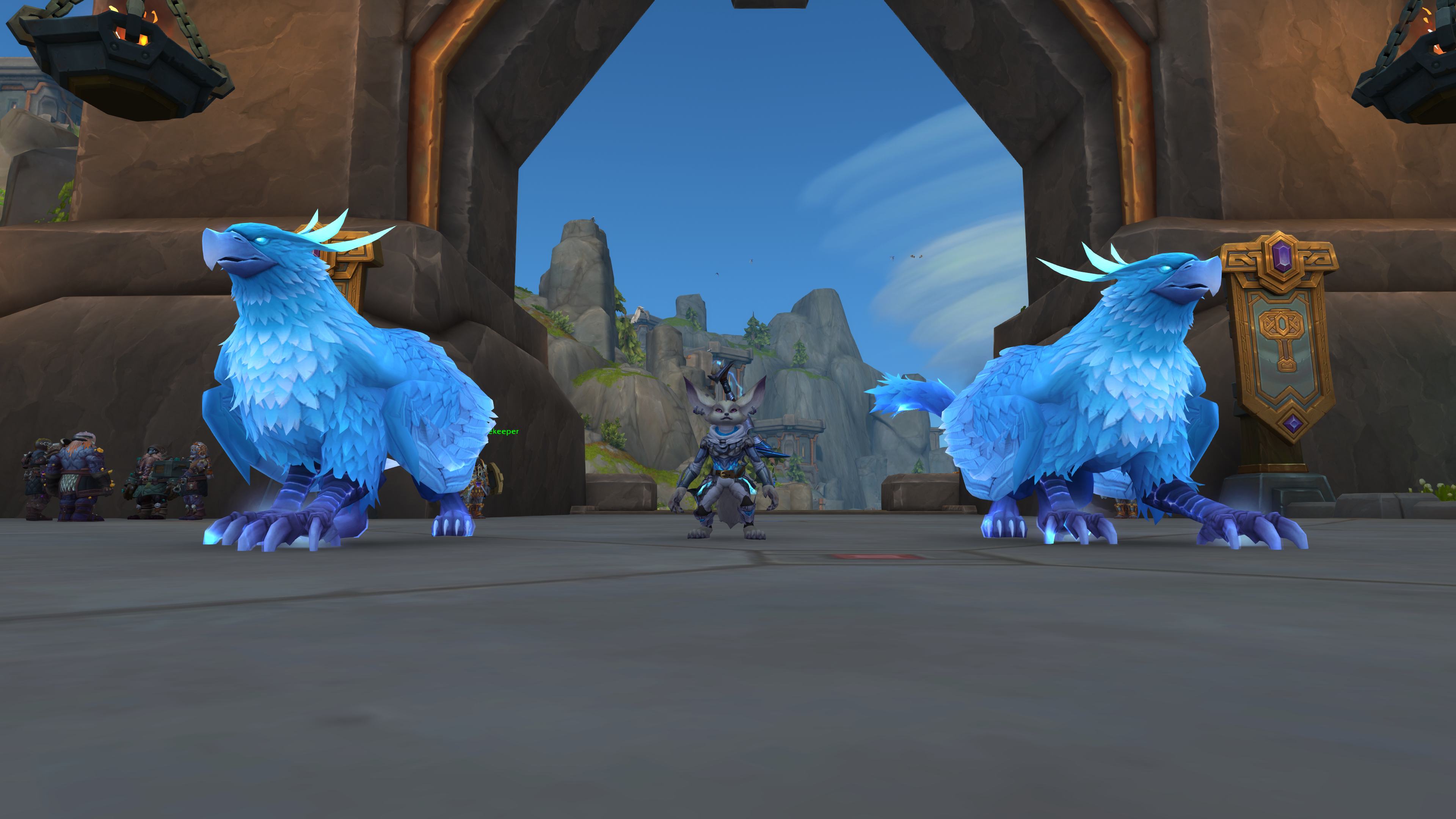 Two blue gyphons standing on either side of a Vulpera in World of Warcraft The War Within