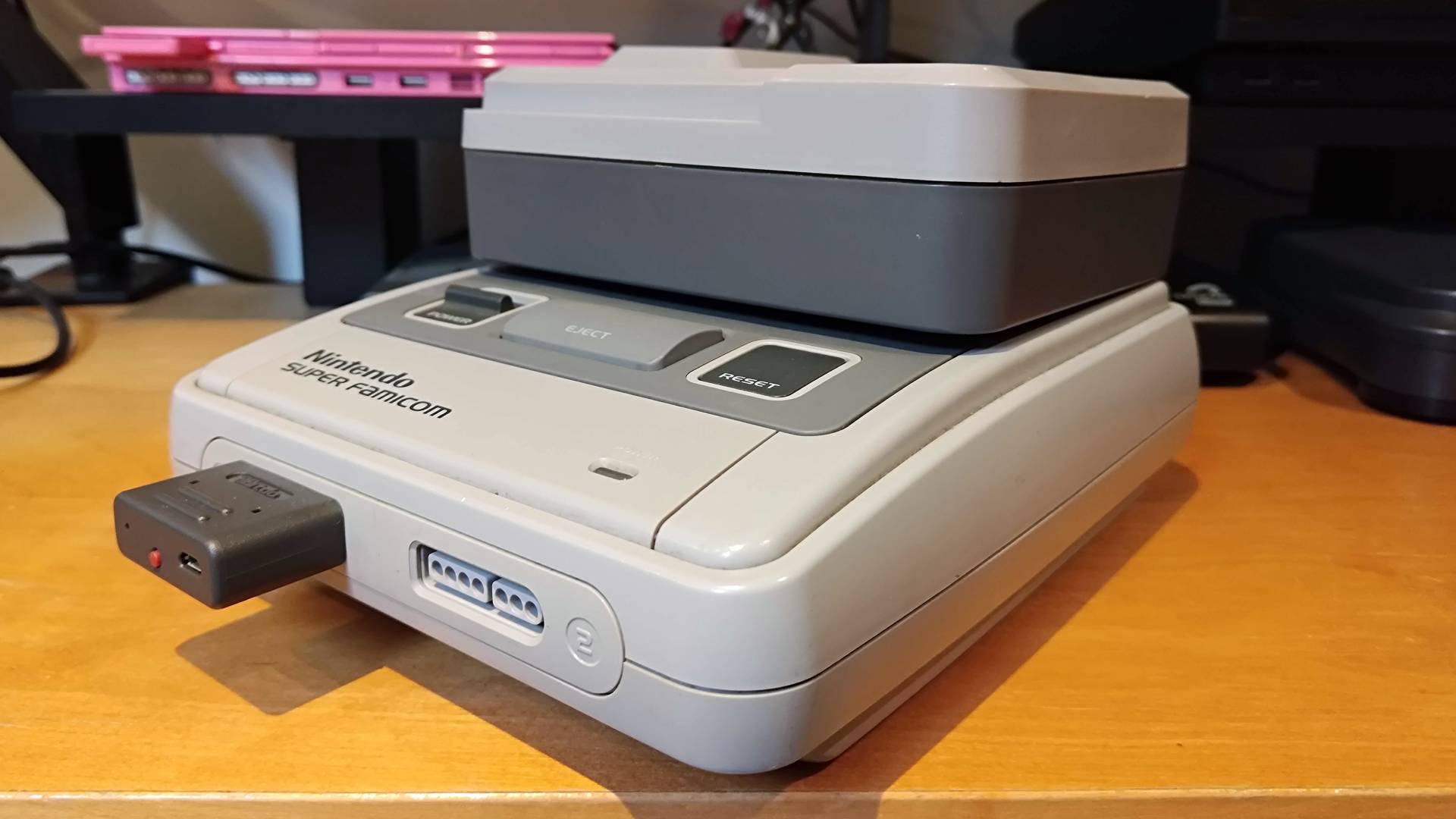 Angled view of Super Wild Card connected to Japanese SNES (Super Famicom). 