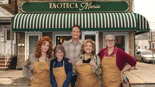Four women and a man standing in front of a restaurant in Nonnas