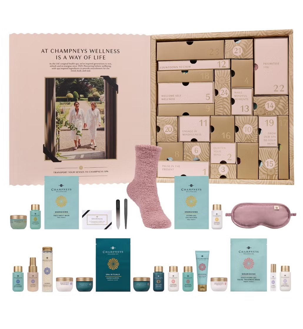 Champneys 24 Days Of Spa Glow Advent Calendar with its contents in front of it