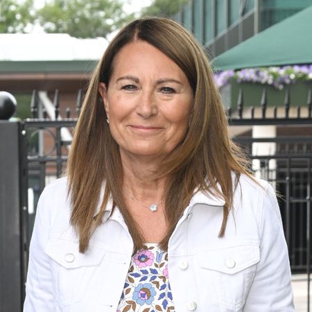 Carole Middleton wearing a white denim jacket and a floral dress at Wimbledon 2022 at the All England Lawn Tennis and Croquet Club on June 29, 2022 