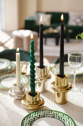 Green spiral candles on a table.