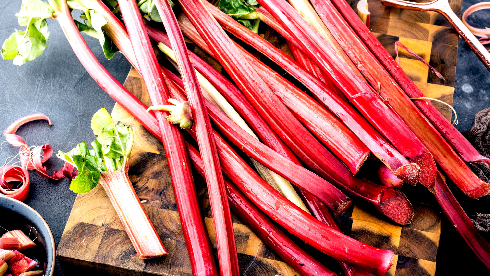 rhubarb stalks freshly harvested on chopping board