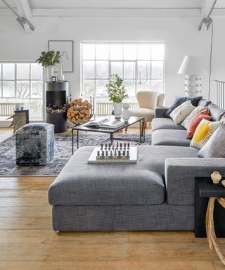 Open plan living room with white walls and l-shaped sofa