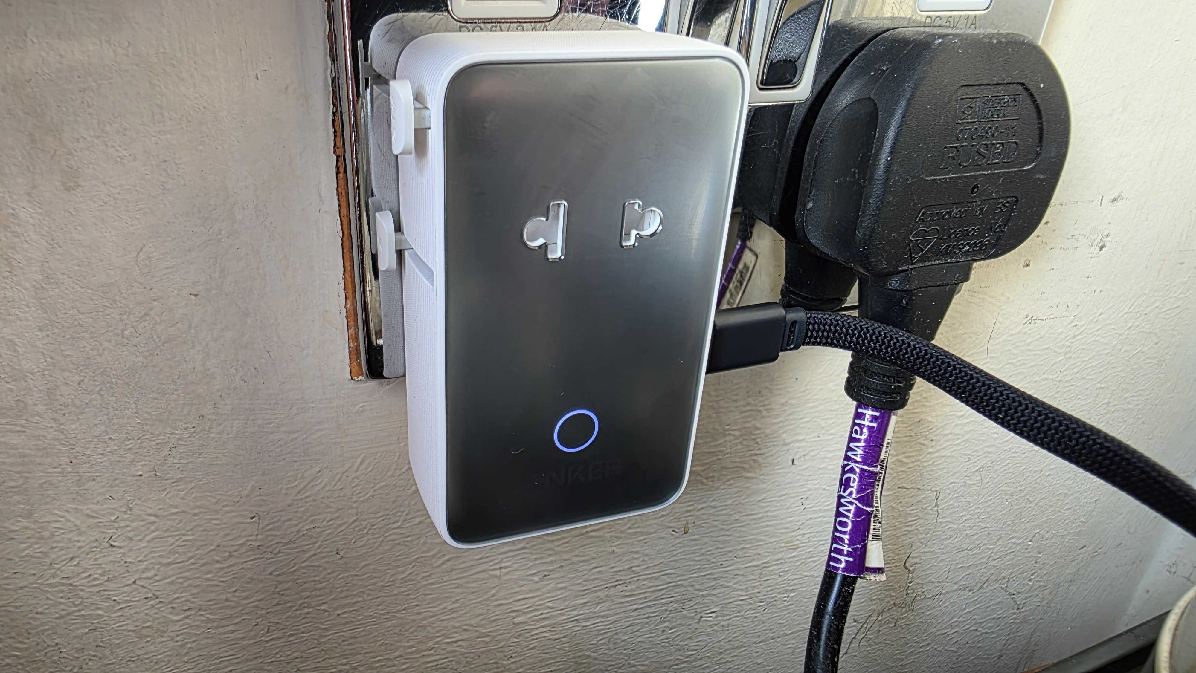 Anker Nano power adapter plugged into a UK outlet