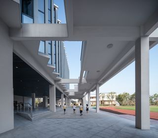 Bottom level of the school building with the sports field next to it.