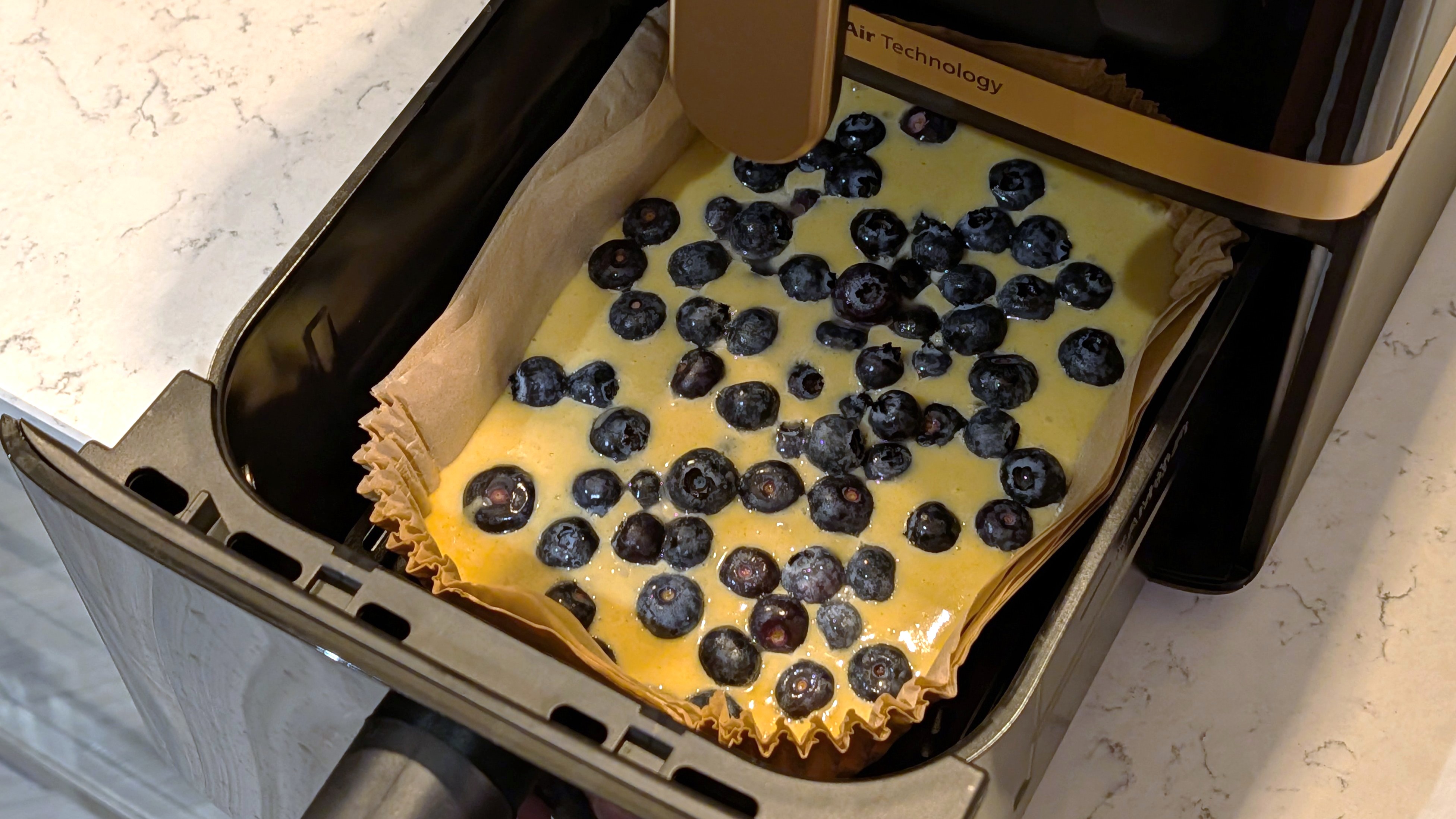 Uncooked cake inside Philips 4000 Series Airfryer drawer