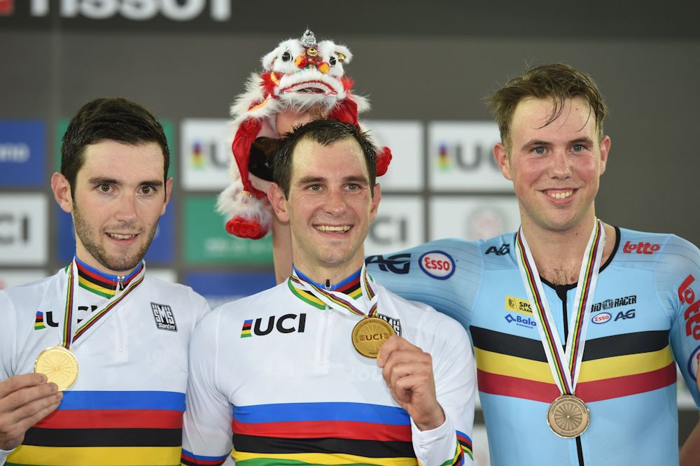 Gold medallist Benjamin Thomas (L) and Morgan Kneisky of France (C) pose with bronze medalist Moreno De Pauw of Belgium on the podium after the men's madison final at the Hong Kong Velodrome during the Track Cycling World Championships