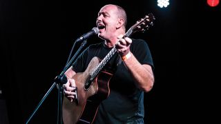 A photograph of Francis Dunnery on stage