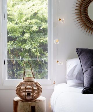 Brass battery-operated micro festoon bedroom fairy lights by Lights4Fun in bedroom draped around window