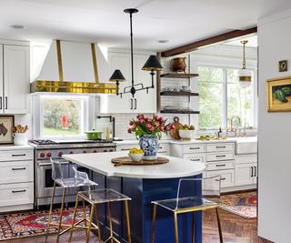 kitchen with white cabinets and blue island