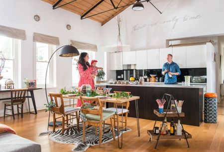 modern festive kitchen with a dining table and Christmas foliage 