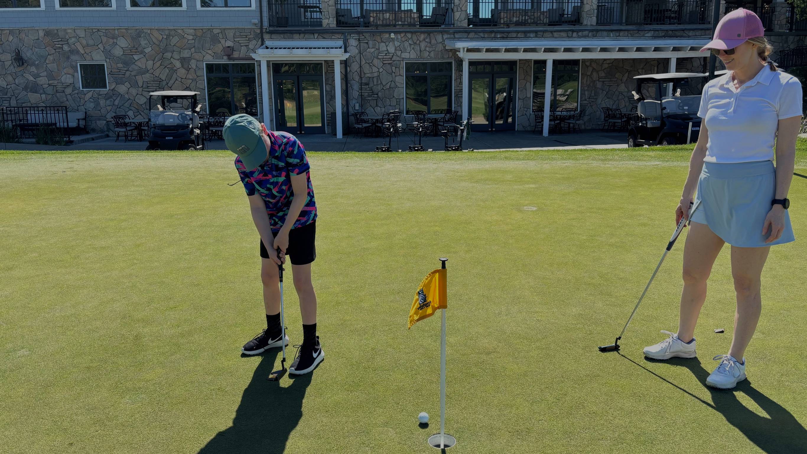 Lauren Katims with her son on the practice putting green