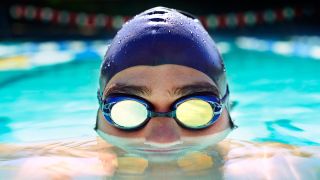 Swimming goggles worn by man in pool