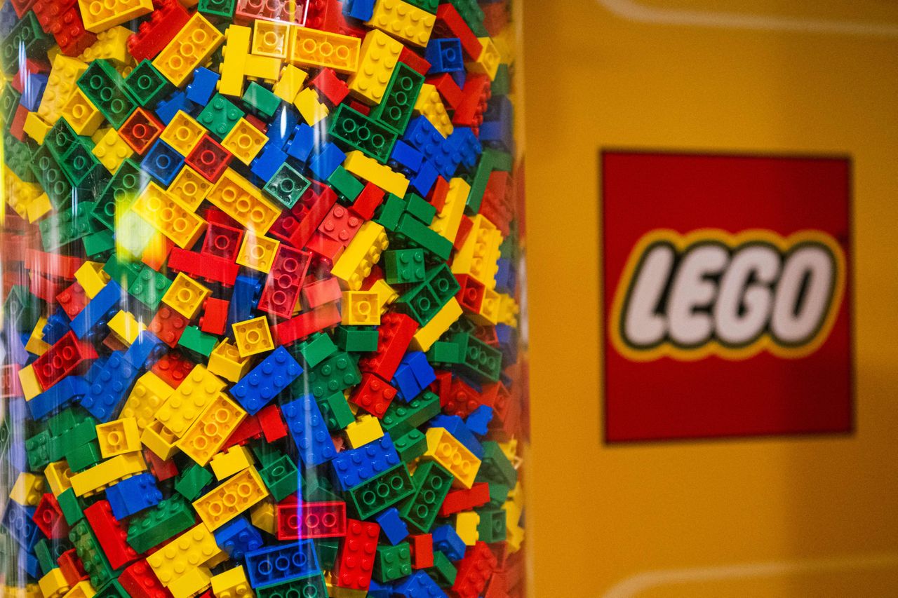 LEGO bricks in clear container with LEGO logo to the side