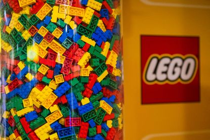 LEGO bricks in clear container with LEGO logo to the side