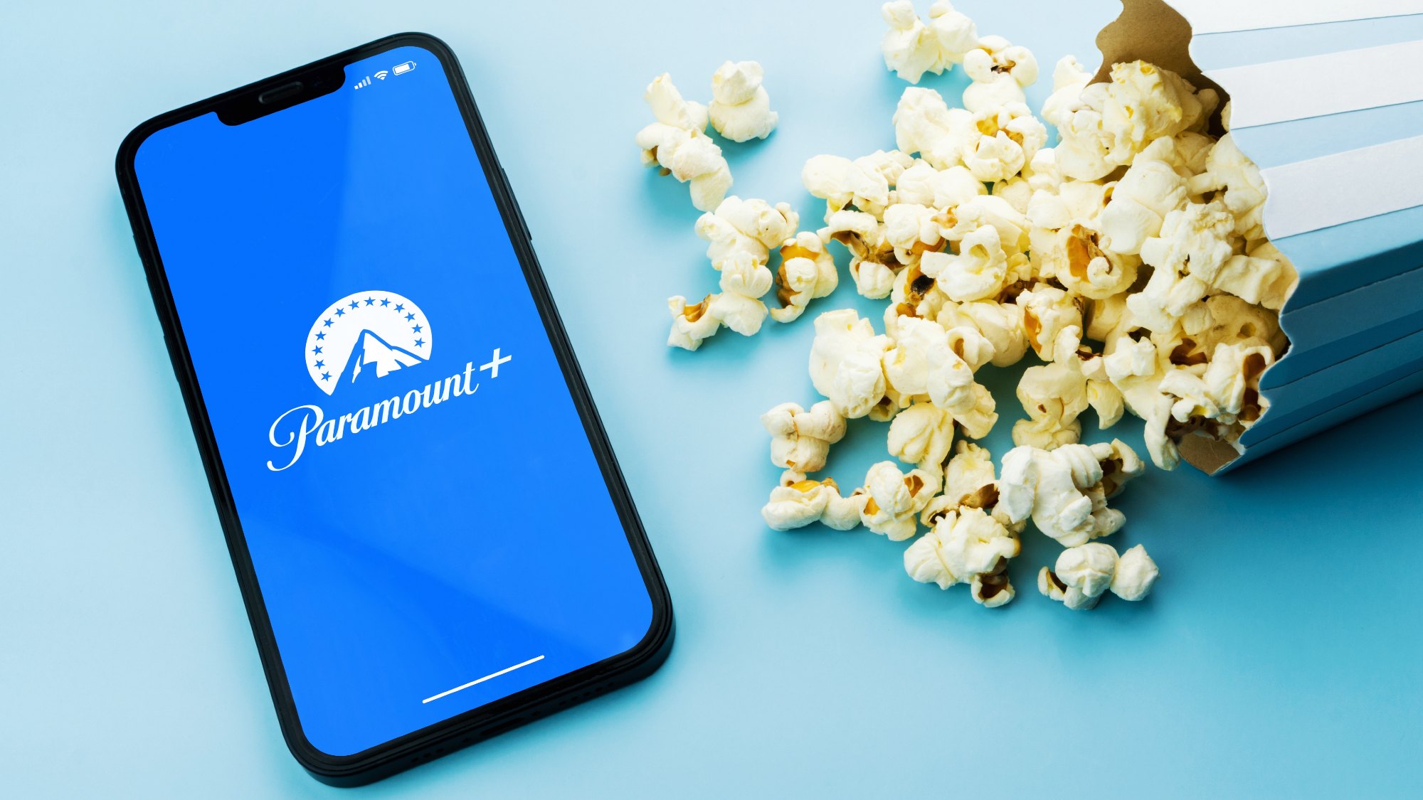 Paramount Plus app on a phone next to popcorn