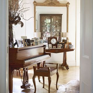 sitting room with wooden flooring and piano