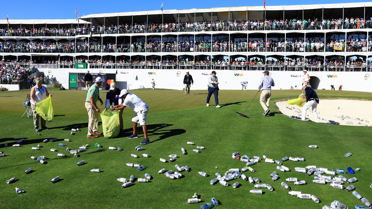 Groundskeepers clear up debris on the 16th green during the 2022 WM Phoenix Open