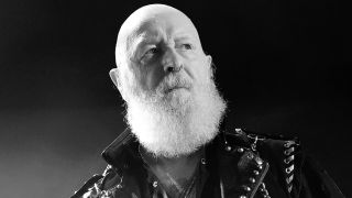 Rob Halford on stage looking serious: the photo is black and white