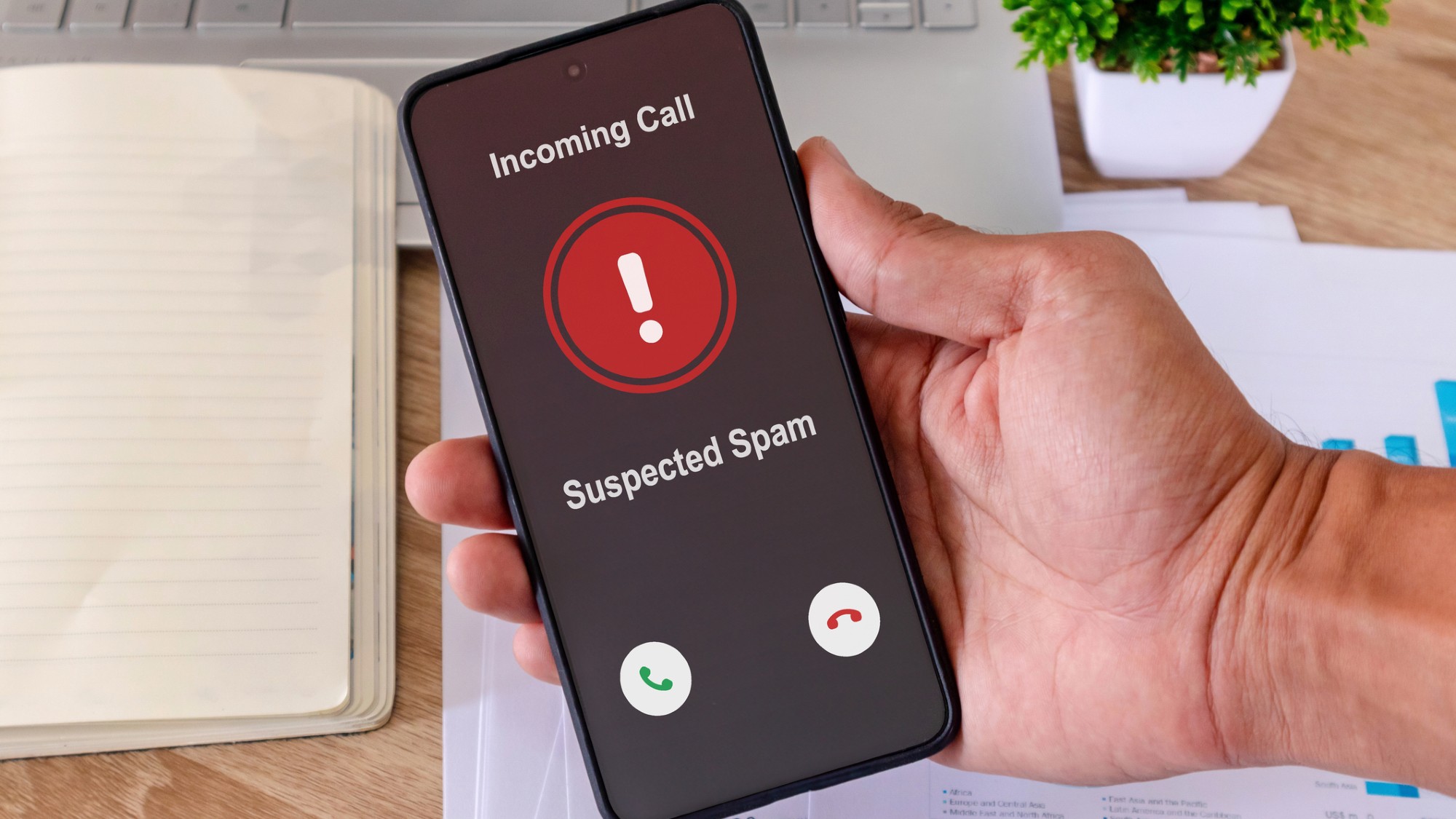 A cell phone displays a suspected incoming spam call.