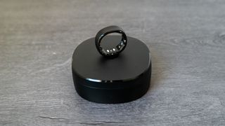 The RingConn Smart Ring on top of charging cradle