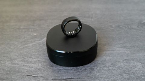 The RingConn Smart Ring on top of charging cradle