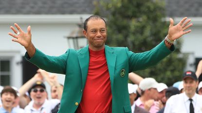 Tiger Woods receives the Green Jacket and celebrates