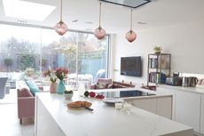 how to design an open plan kitchen: white open plan kitchen and living area