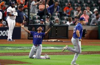 Jose Leclerc #25 of the Texas Rangers celebrates the final out to defeat the Houston Astros in Game Seven to win the American League Championship Series at Minute Maid Park on October 23, 2023