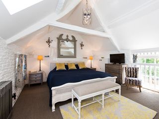 attic white bedroom with bed on carpet floor