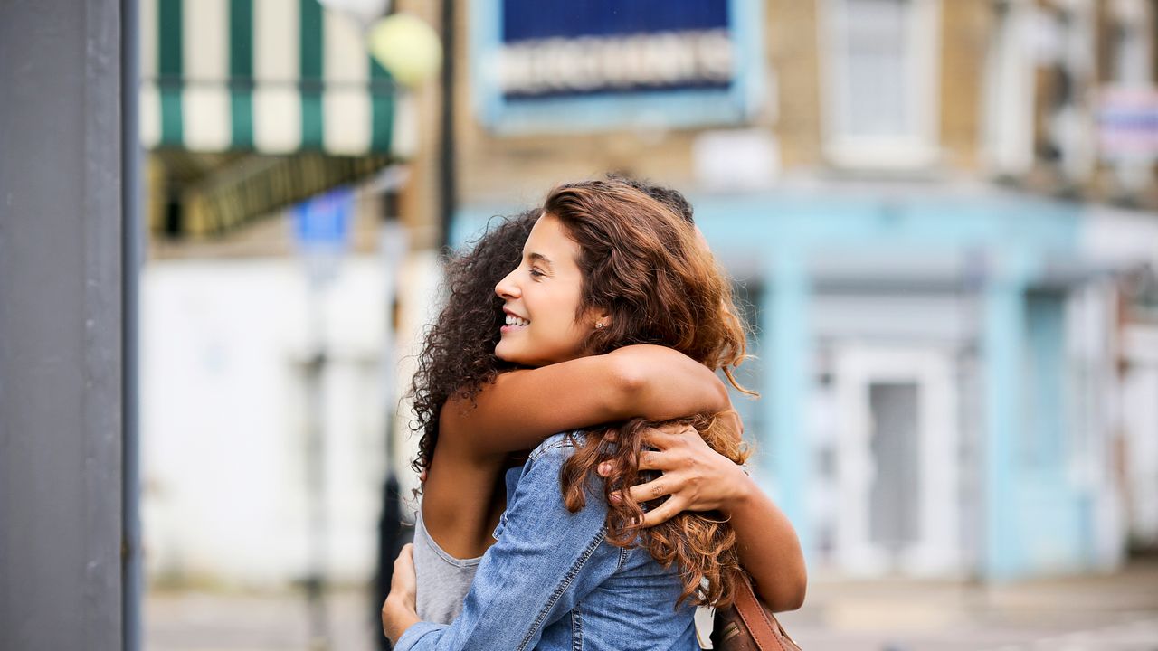 two women hugging outdoors