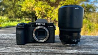 The Fujifilm X-S20 body standing beside a kit lens