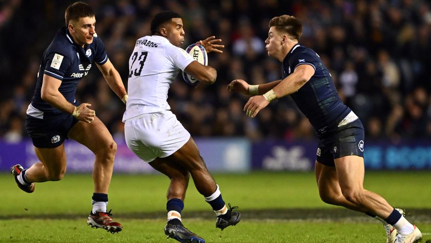 Immanuel Feyi-Waboso of England takes on Cameron Redpath and Huw Jones of Scotland during Scotland vs England in the 2024 Six Nations