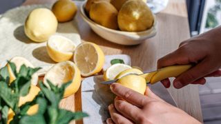 Lemons being cut up on chopping board